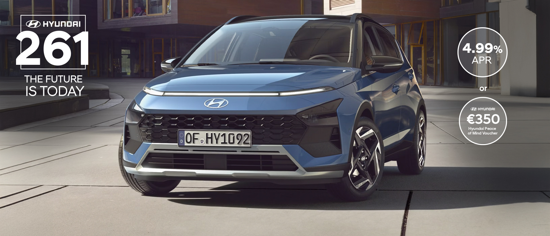 The new Hyundai BAYON is seen the front, with urban housing in the background.