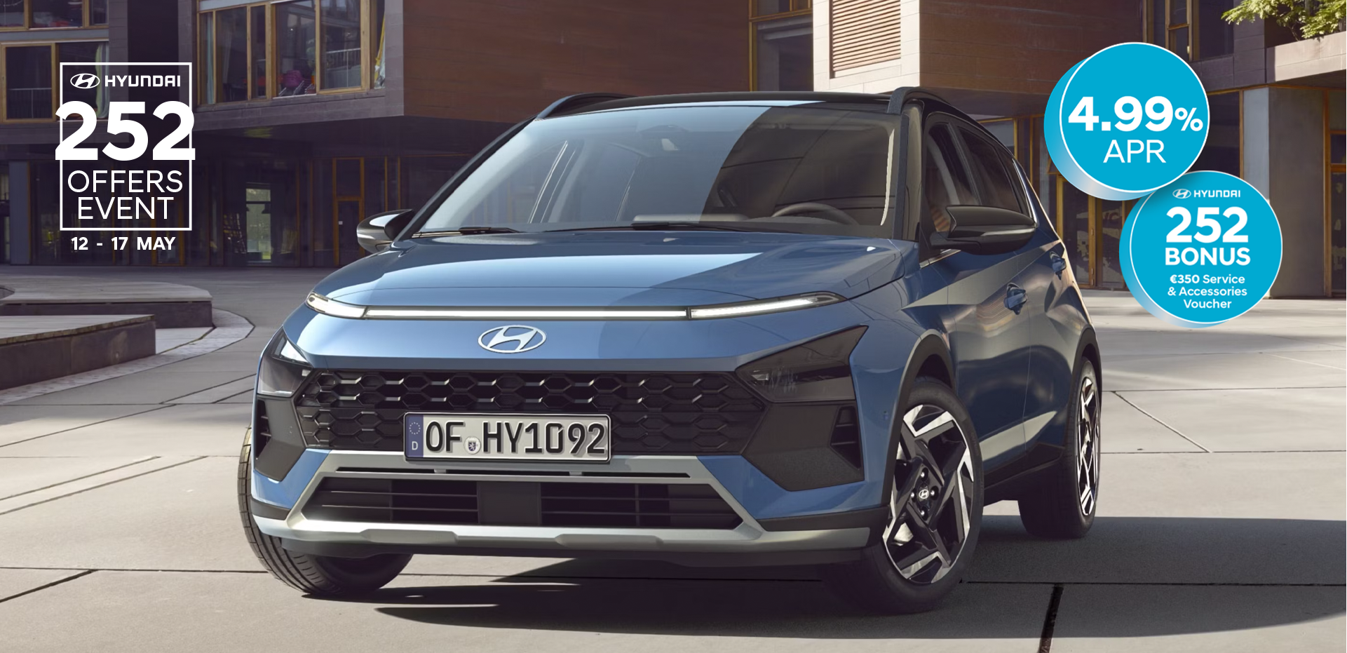 The new Hyundai BAYON is seen the front, with urban housing in the background.