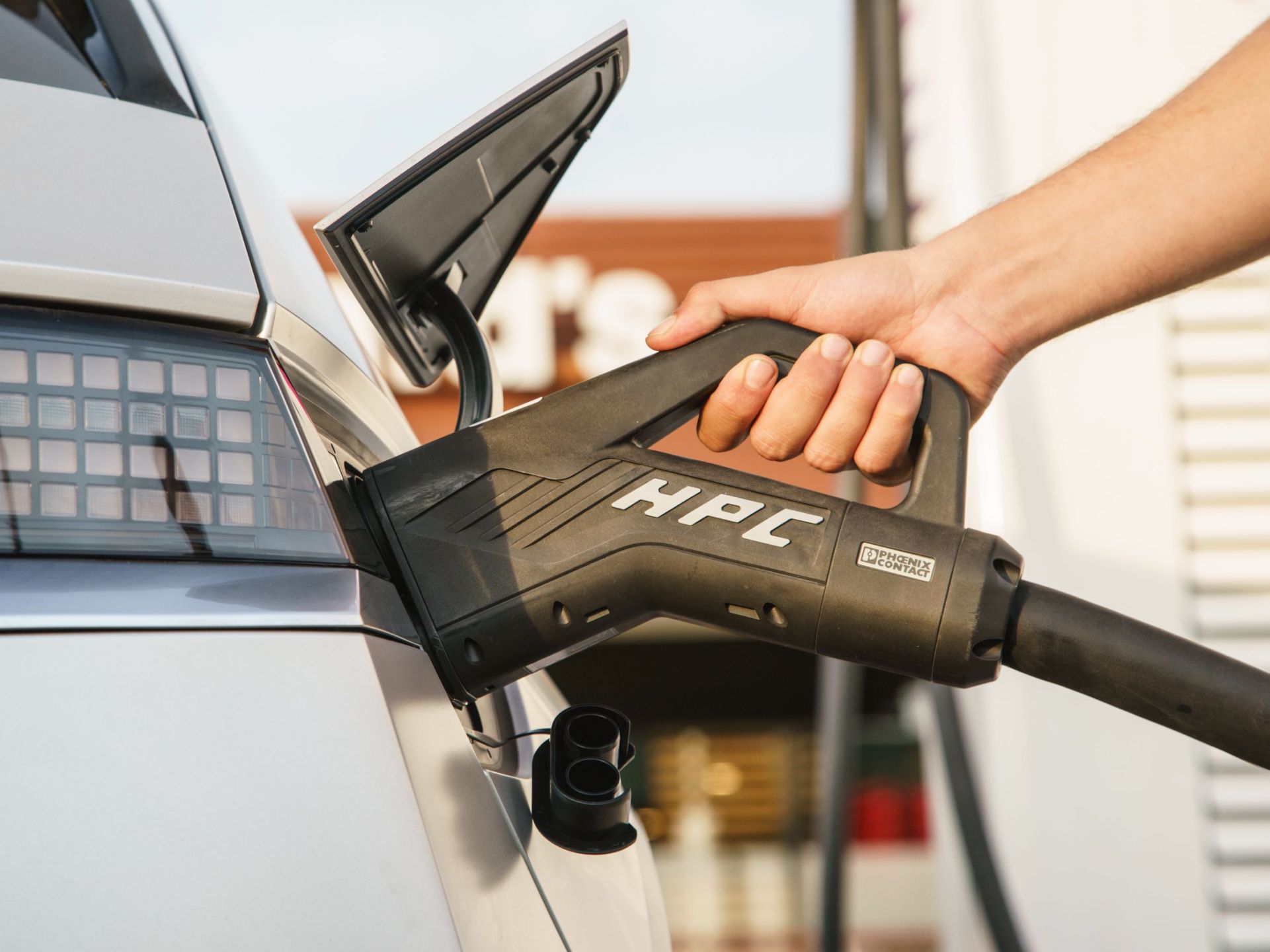 A Hyundai IONIQ 5 getting plugged in to an IONITY Combined Charging System.