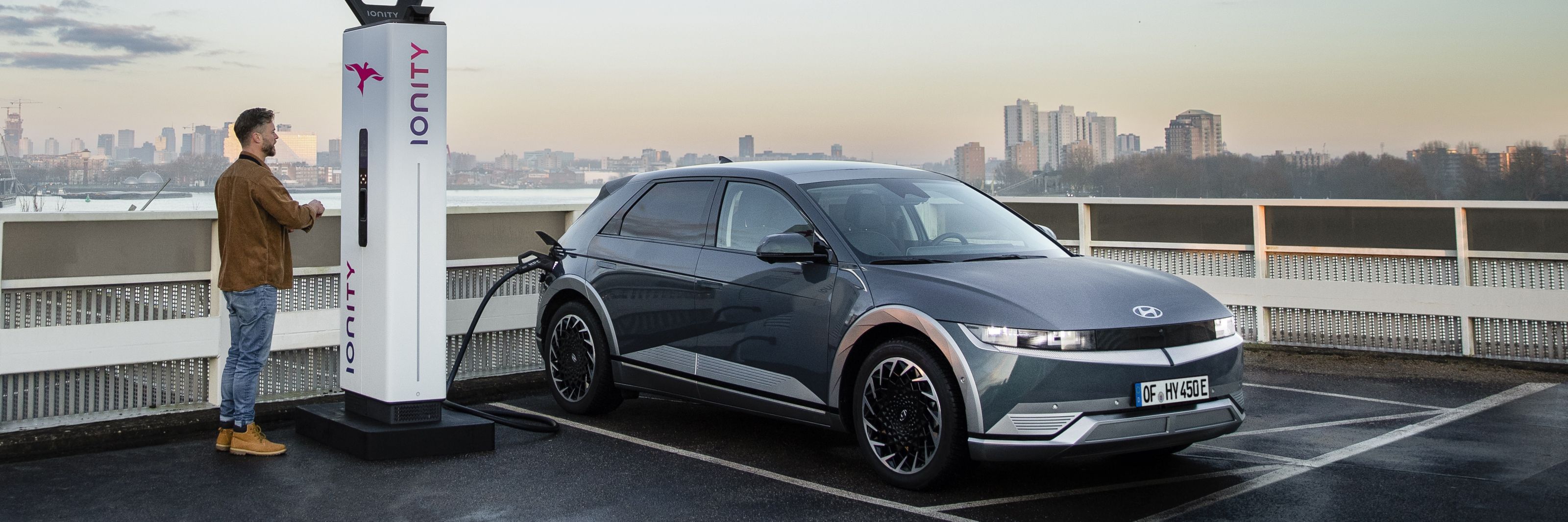 The Hyundai IONIQ 5 electric vehicle charging at an IONITY charging station on a rooftop.