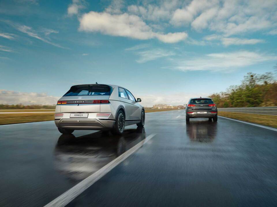 Hyundai IONIQ 5 electric midsize CUV travelling along a country road.