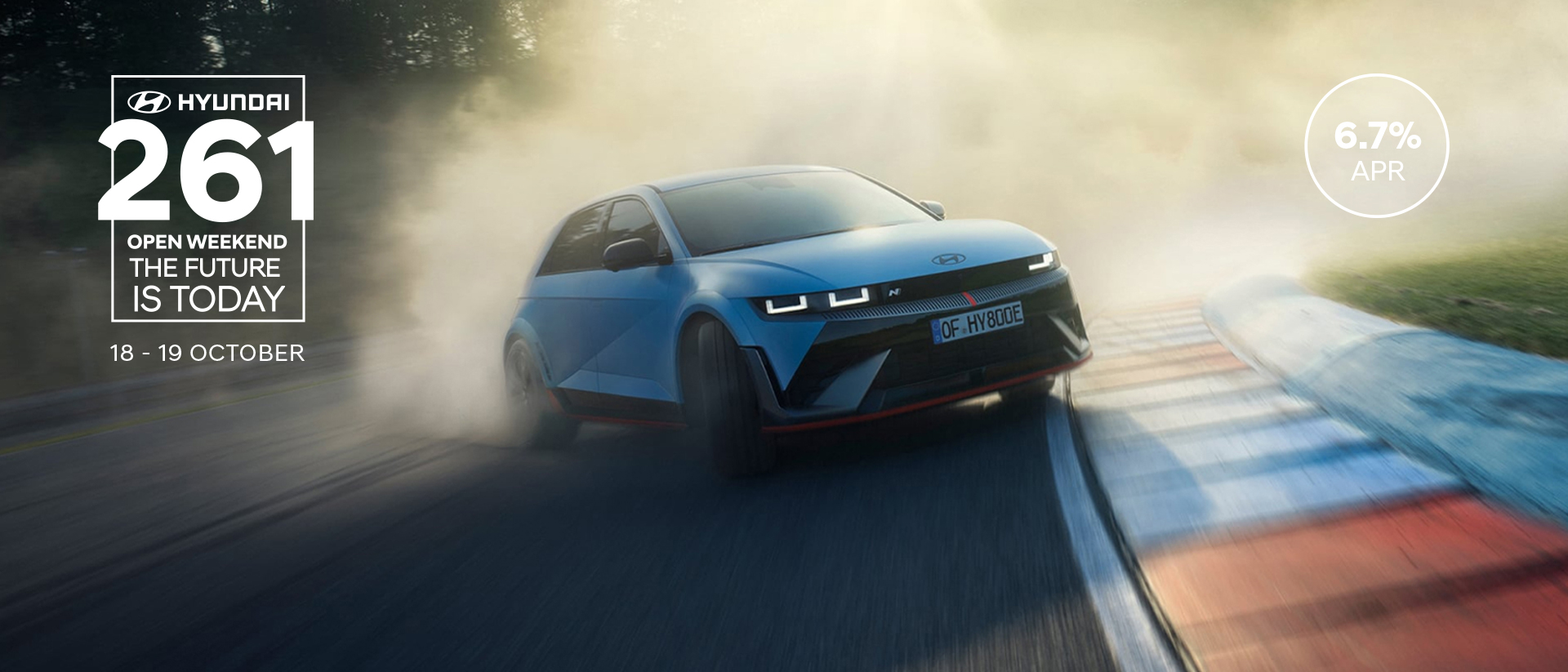 The all-electric Hyundai IONIQ 5 N drifting through a curve on a racetrack with smoking tyres.