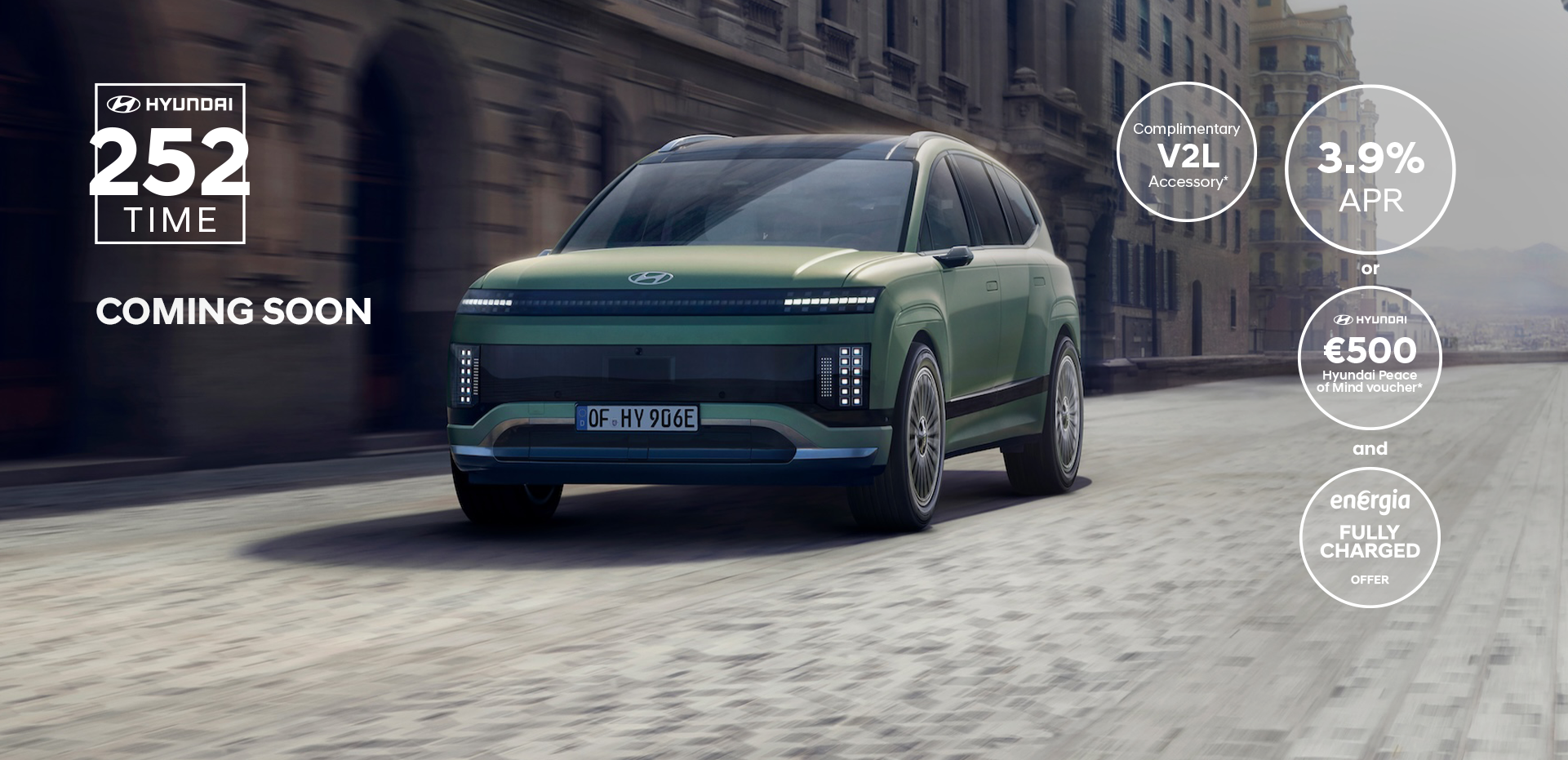 Three-quarter view of the new Hyundai IONIQ 9 driving in the city.	