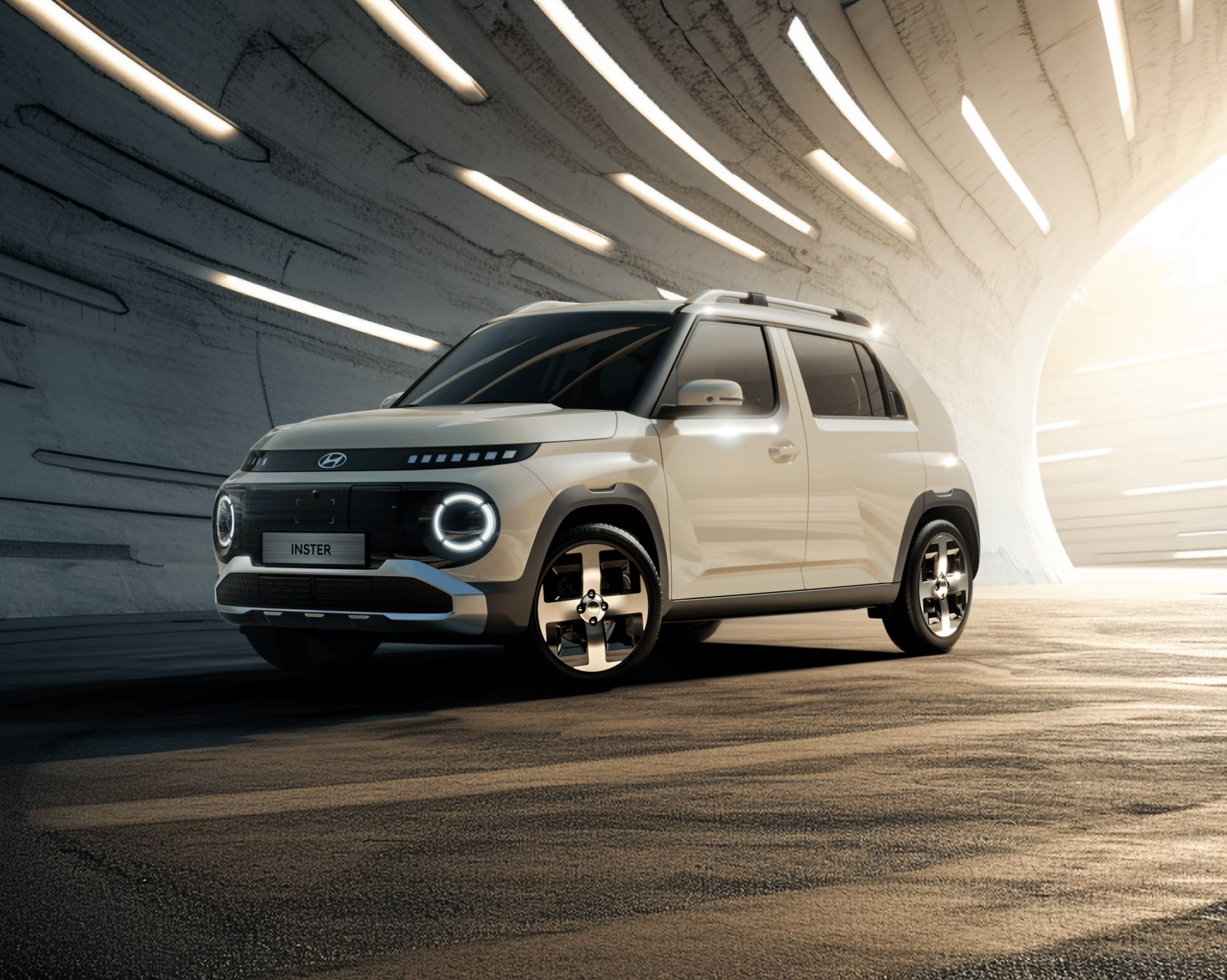 The new Hyundai INSTER small electric car parked in a tunnel with dramatic lighting.