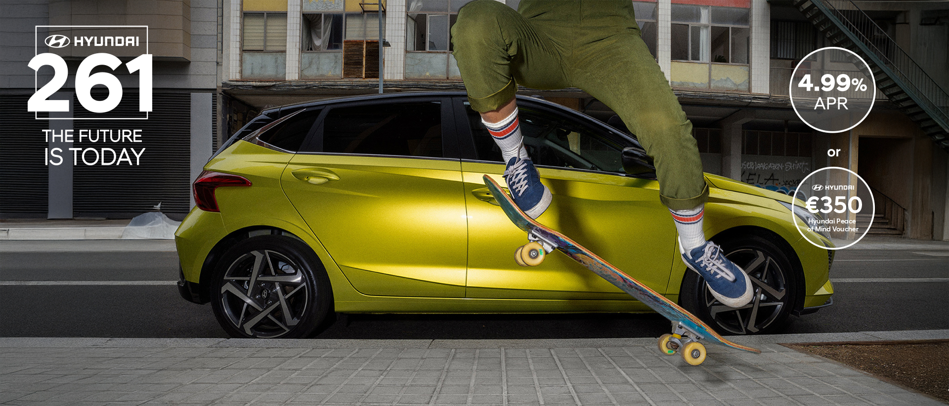 A young woman skateboarding in the street with a Hyundai i20 in the background.