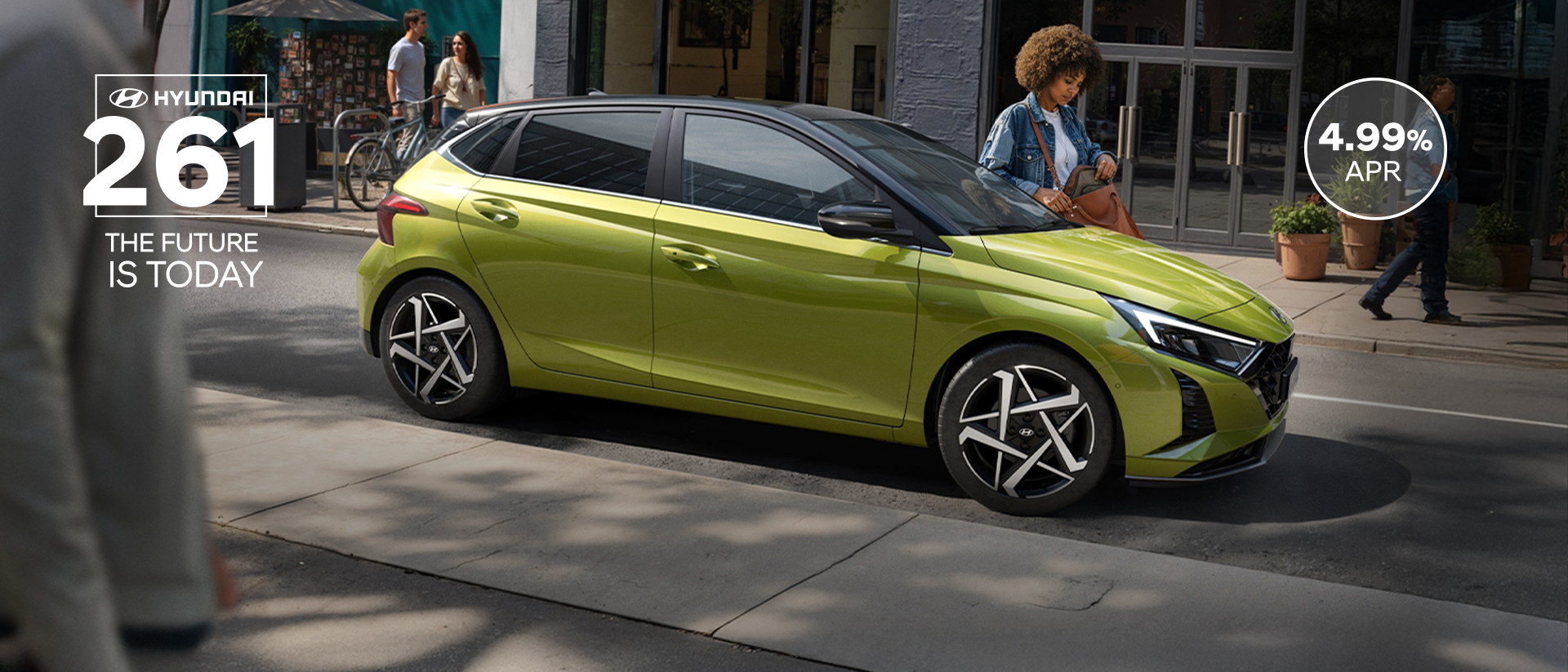 A young woman skateboarding in the street with a Hyundai i20 in the background.	
