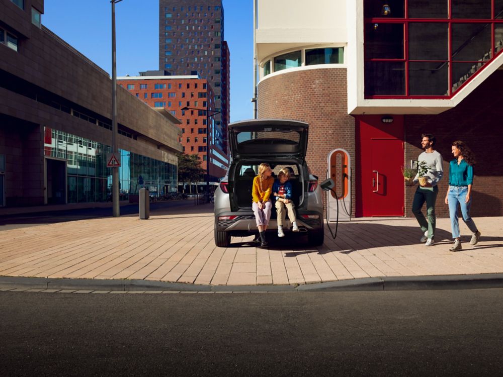 Family in the trunk of the all-new Hyundai TUCSON Plug-in Hybrid N Line in the city.